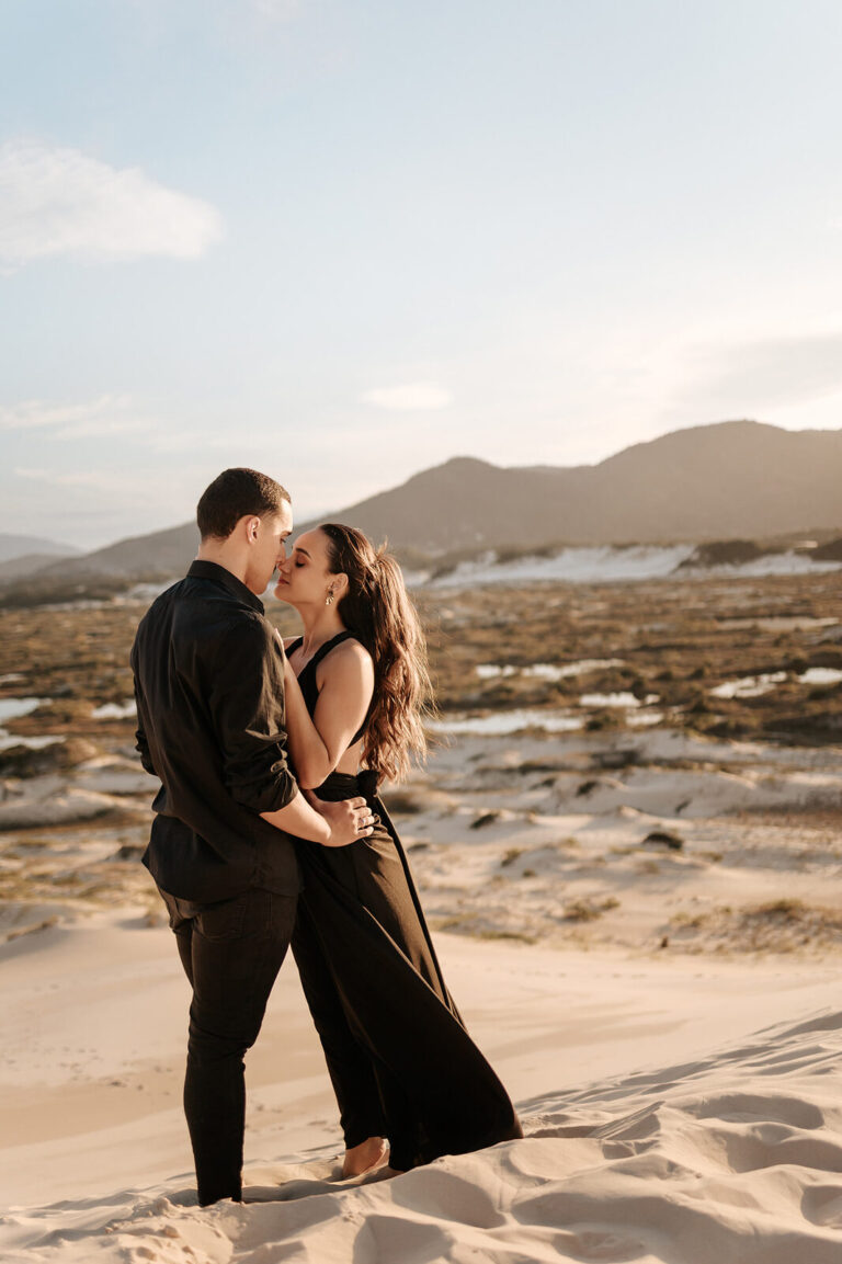 Noivos vestem preto em pré wedding diferente nas dunas